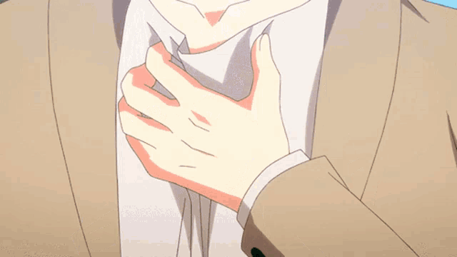 a man in a suit is adjusting his tie with his hand