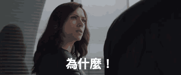a woman in a black jacket is looking at a man in a black shirt with chinese writing on it .