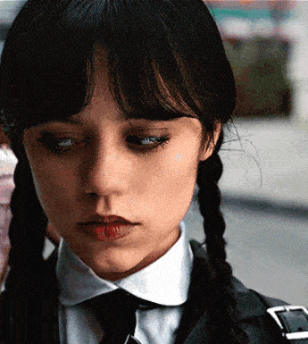 a close up of a girl with pigtails and a tie