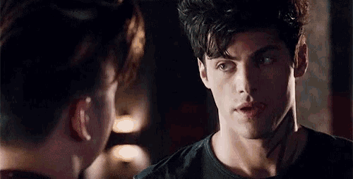 a close up of a man 's face looking at another man 's face .