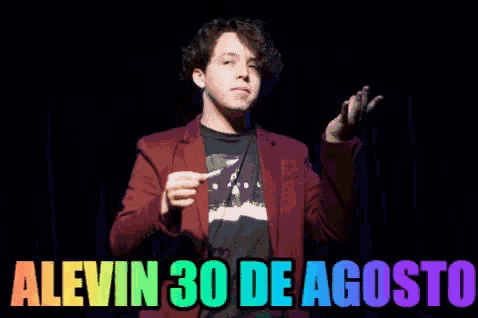 a man in a red jacket lighting a match with the words alevin 30 de agosto written below him