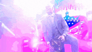 a man in a suit is holding a trophy in front of a sign that says night wars