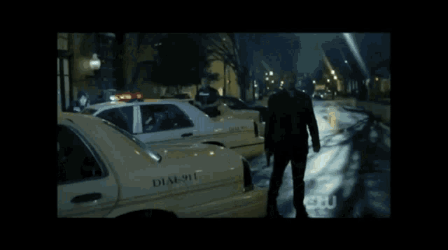 a man standing in front of a dial 911 taxi