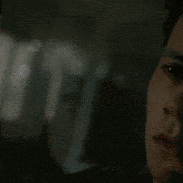 a close up of a young man 's face in the dark