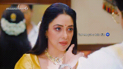 a woman in a yellow blouse is looking at a man in a white shirt .