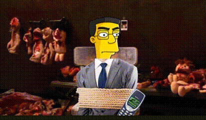a man in a suit and tie is tied up and holding a nokia phone