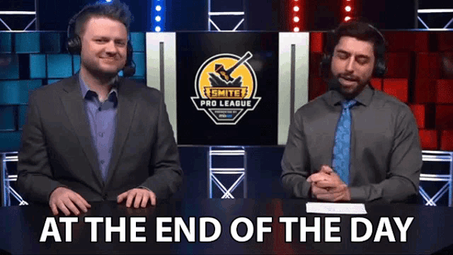 two men are sitting in front of a smite pro league logo