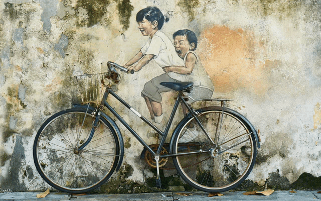a painting of a boy and a girl riding a bike on a wall