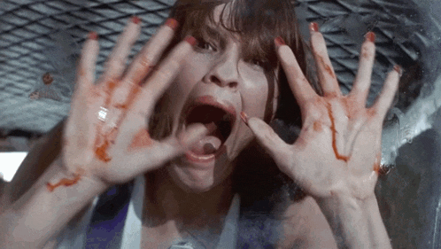 a woman with bloody hands covering her face