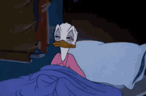 donald duck is sleeping in a bed with his eyes closed