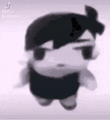 a stuffed animal with a black hair and a white shirt is standing on a white surface .
