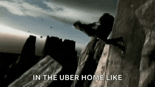 a man is climbing up a rock wall with the words in the uber home like below him .