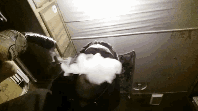 a person smoking a cigarette with a can that says tiger