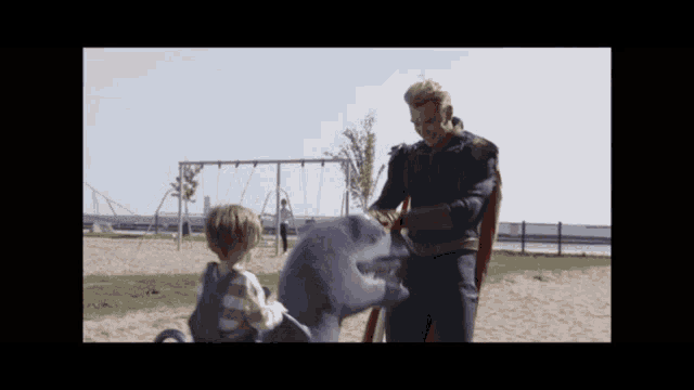 a man in a superhero costume playing with a child