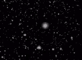the snow is falling in the night sky on a black background .