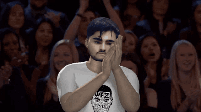 a man wearing a white shirt with a skull on it applauds