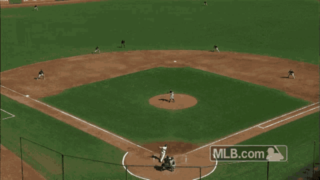 a baseball field with a mlb.com logo on the side