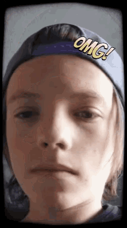 a young boy wearing a hat that says " omg " on it