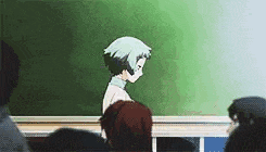 a group of people are sitting in a classroom in front of a blackboard .