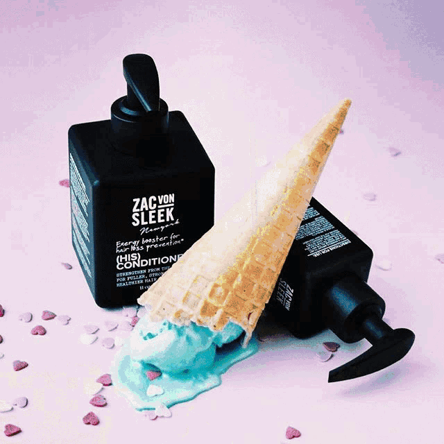 two bottles of zac von sleek shampoo and conditioner on a green surface