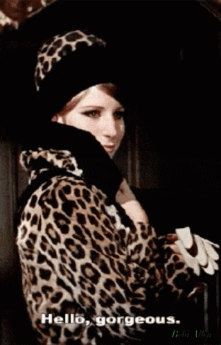 a woman wearing a leopard print coat and hat says hello gorgeous