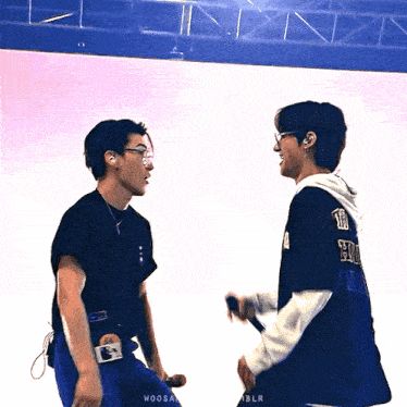 two men standing next to each other with one wearing a shirt that says ' woosa '
