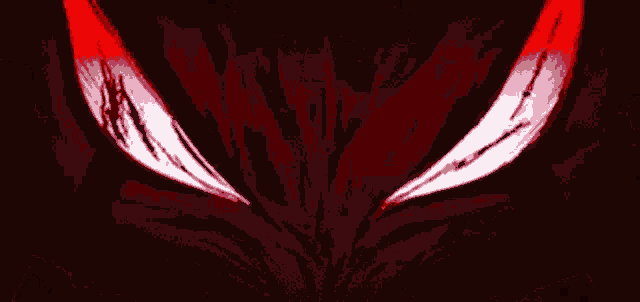 a close up of a person 's eyes in the dark with a red light coming out of them .
