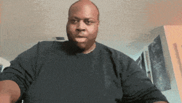 a man wearing a black shirt looks at the camera