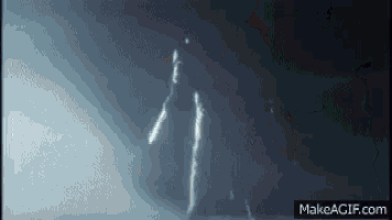 a silhouette of a person standing in a dark room with a light coming from behind them .