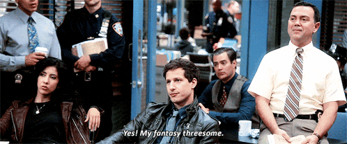 a group of people are sitting around a table and one of them says yes my fantasy threesome