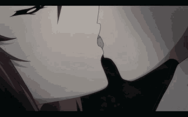 a close up of a couple kissing each other