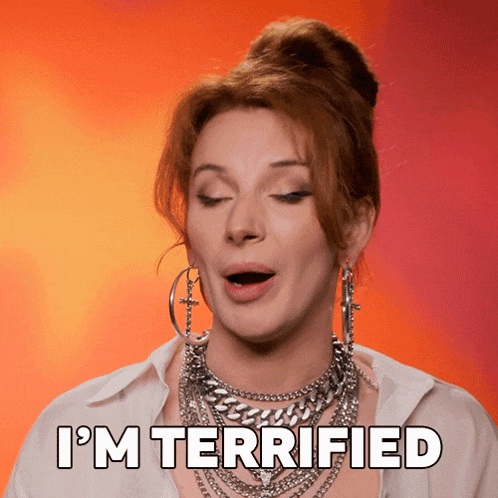 a woman with a bun says i 'm terrified with her mouth open