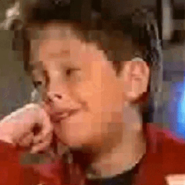 a blurry picture of a man 's face with a red shirt on