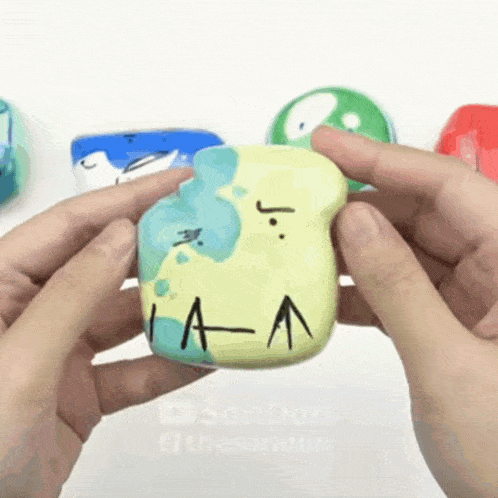 a person is holding a rock that has the letter a on it