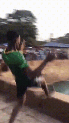 a person in a green shirt is kicking something