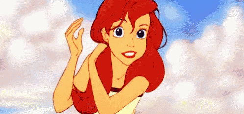 ariel from the little mermaid is standing with her arms crossed and smiling .