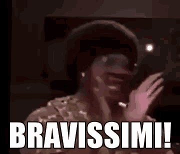 a man in a hat is making a funny face and saying bravissimi !