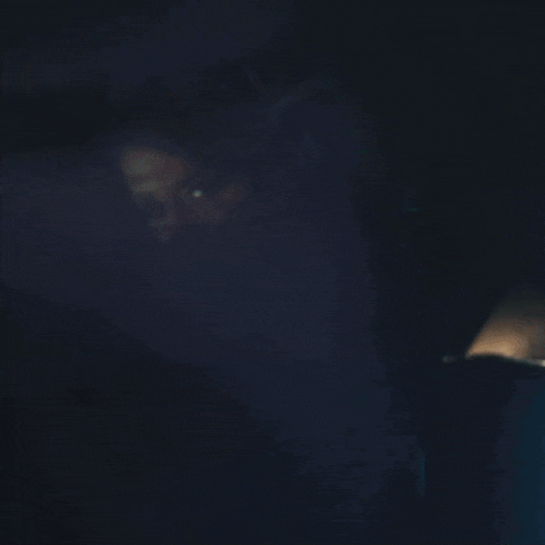 a woman in a blue dress is screaming with her mouth open
