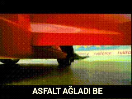 a person is walking under a red couch with the words asfalt agladi be below it