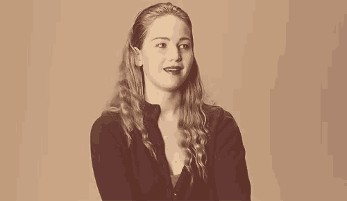 a woman with long blonde hair is wearing a black shirt