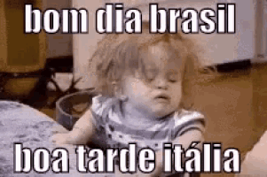 a baby is sitting on a couch with a caption that says bom dia brasil boa tarde italia