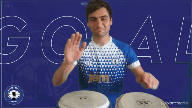 a man in a blue shirt with the word em on the front