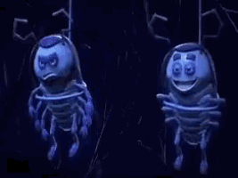 two blue cartoon bugs are hanging from a rope in the dark .