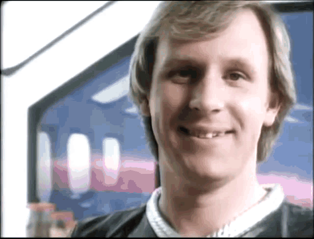 a close up of a man 's face with a smile on his face