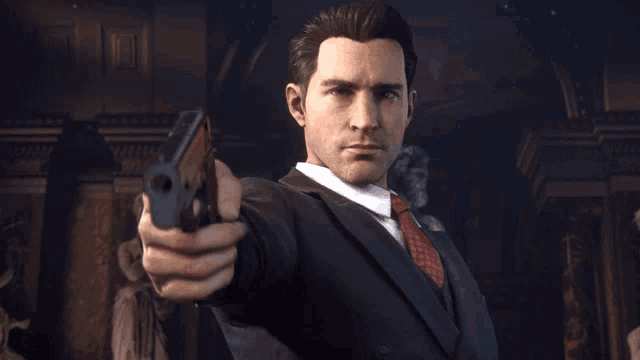 a man in a suit and tie pointing a gun at the camera