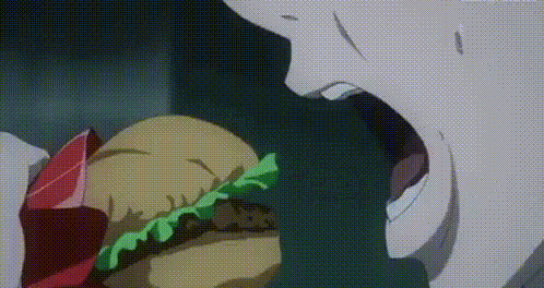 a close up of a person eating a hamburger with lettuce and meat .