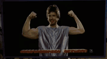 a man flexes his muscles in front of a screen that says rick thompson