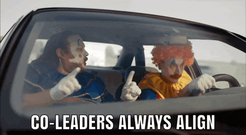 two clowns are sitting in a car with the words co-leaders always align