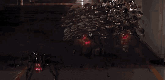 a dark room with a red light coming out of the ground