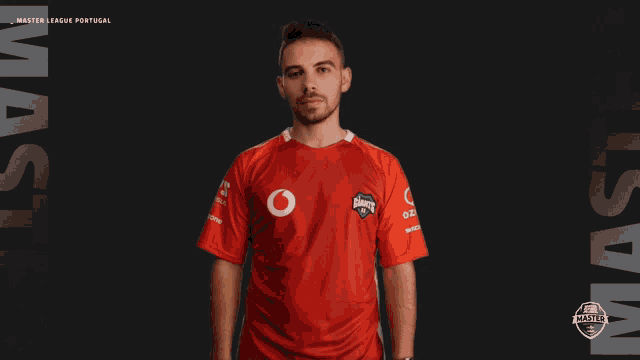 a man wearing a red shirt that says master league portugal on it